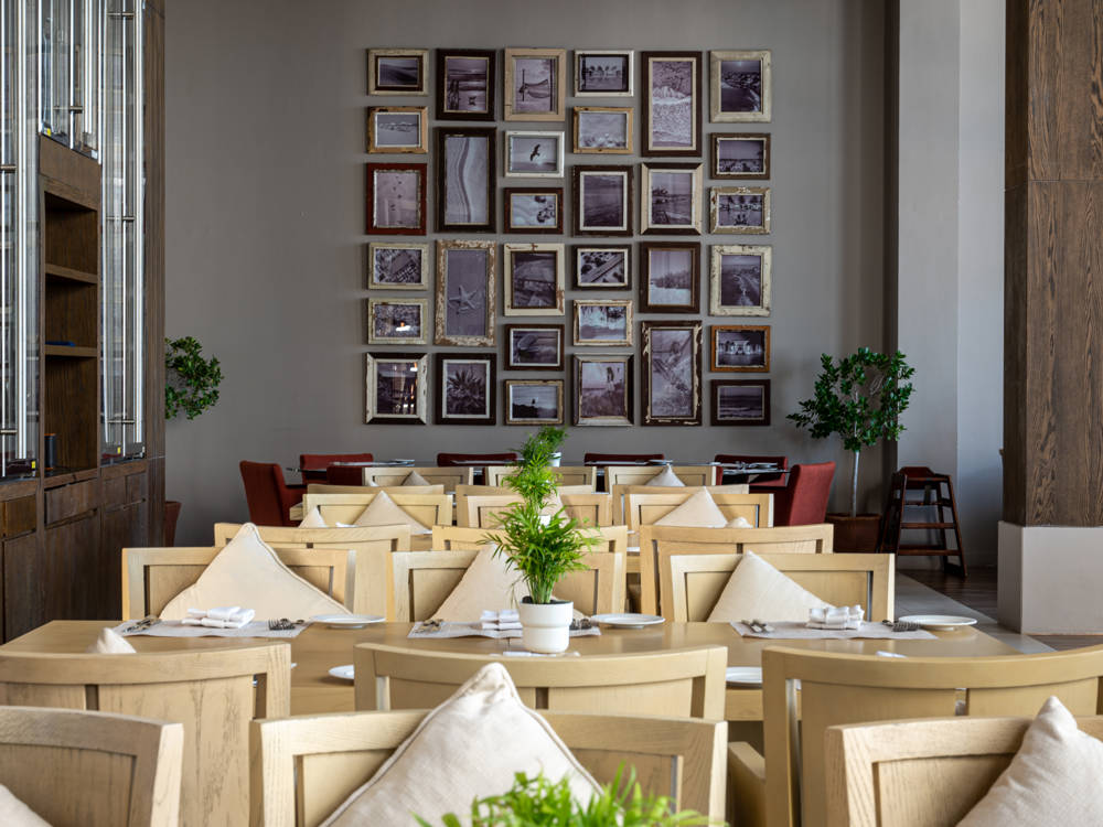 Safina Restaurant at Saadiyat Beach Club with airy, coastal-themed seating perfect for relaxed beachfront dining.