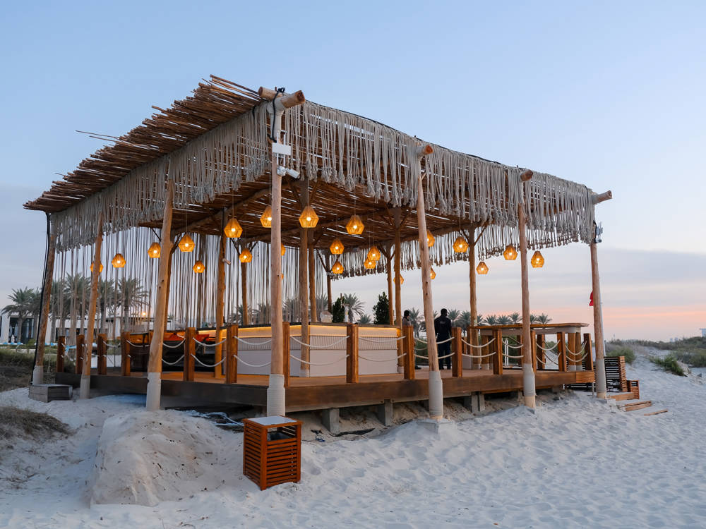 The Beach Bar at Saadiyat Beach Club in Abu Dahbi at sunset. A cosy location to relax on the beach.