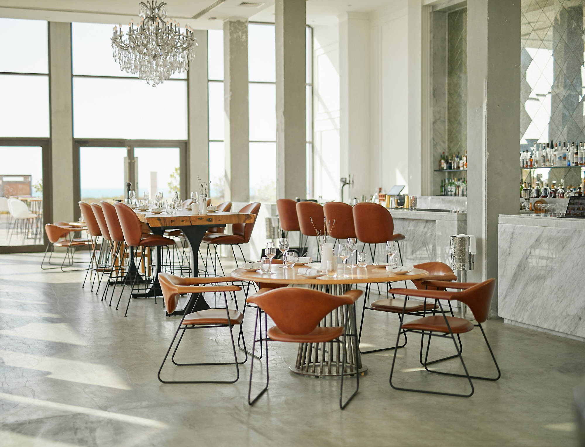 A modern and clean restaurant at Saadiyat Beach Club in Abu Dhabi. The space is naturally lit and inviting.